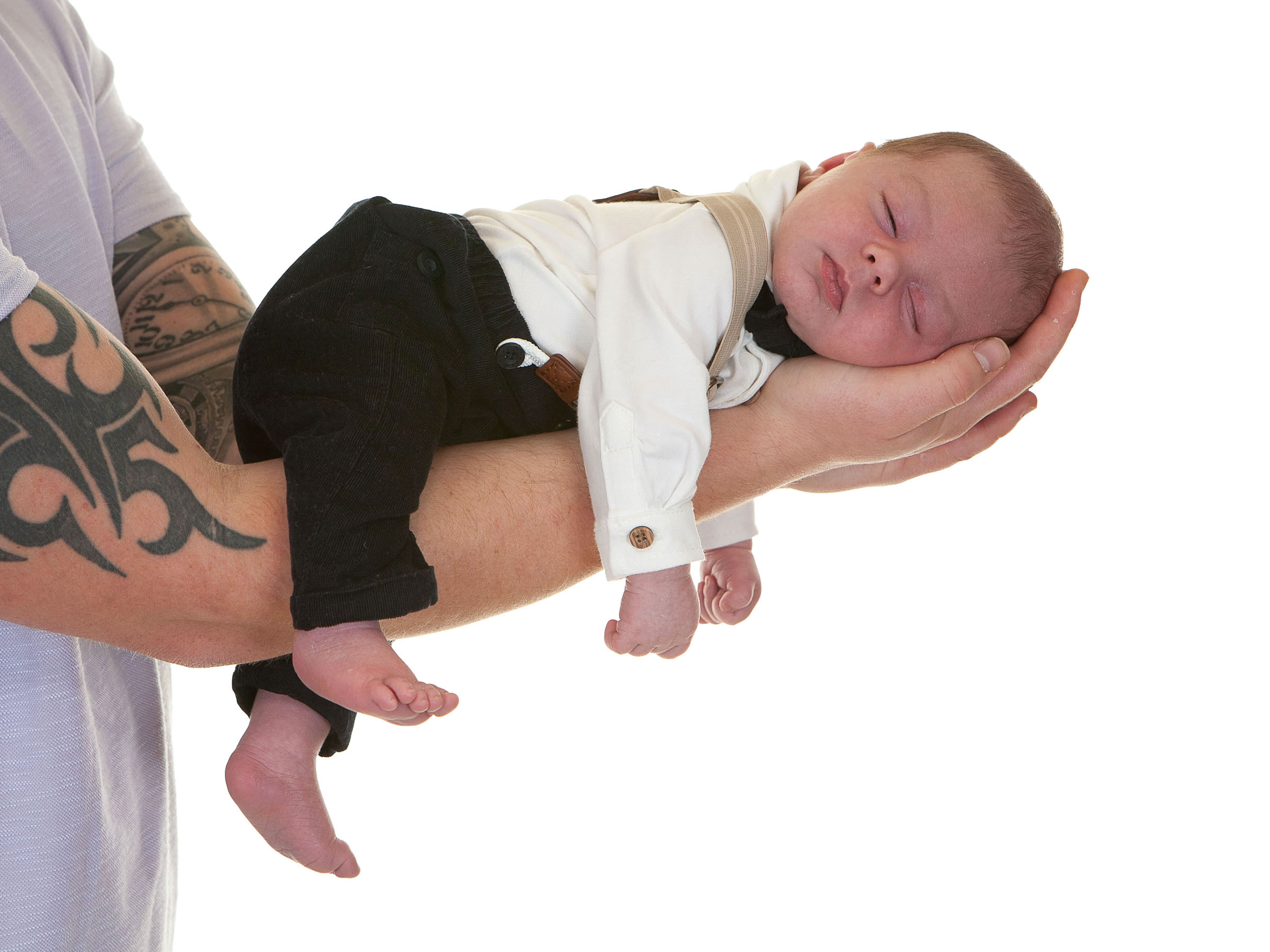 newborn baby sleeps with arms and legs dangling down