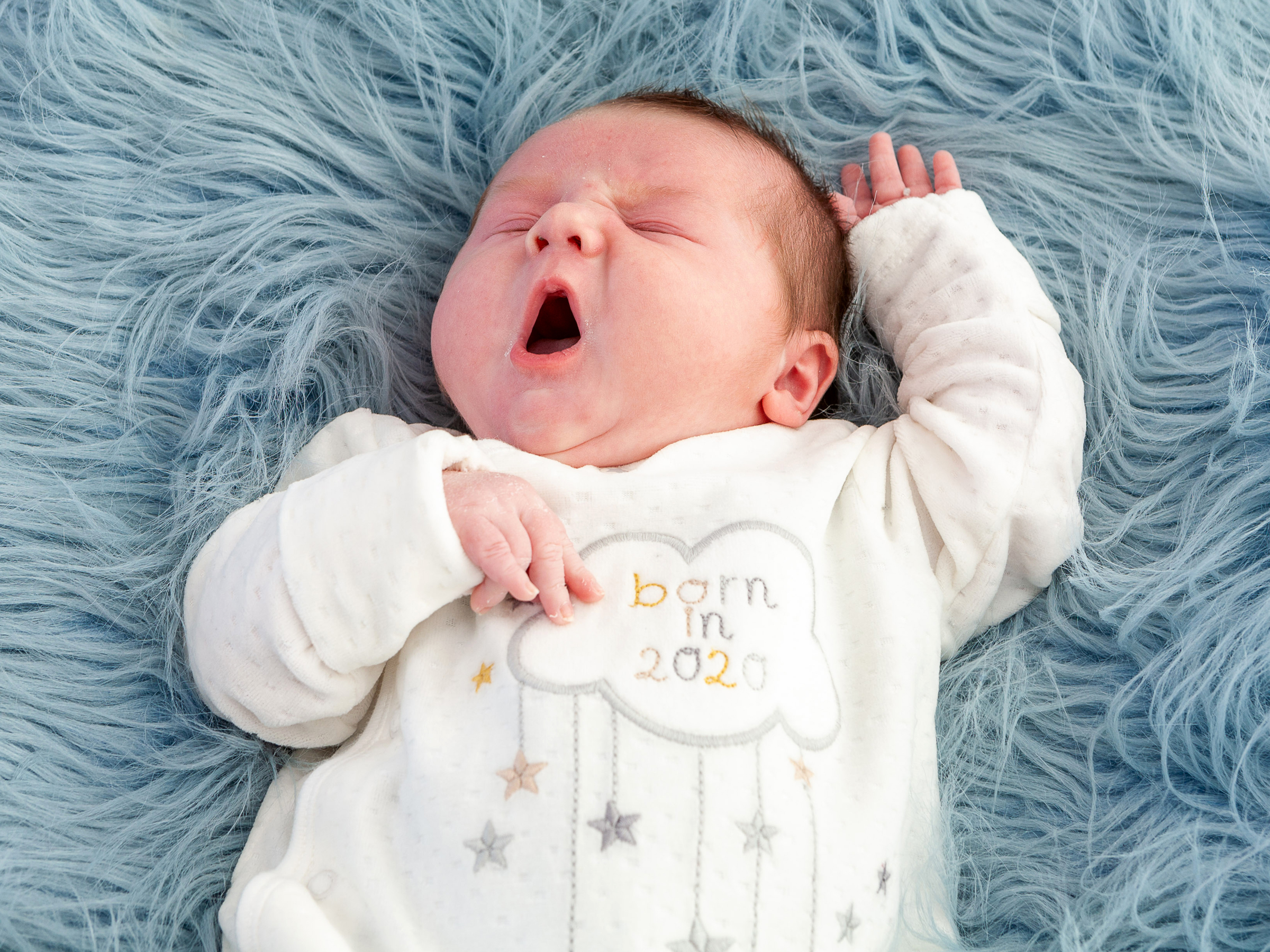 little baby born in 2020 yawning